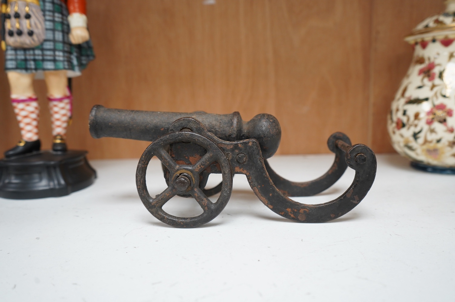 A miniature cast iron table canon, 19cm in length. Condition - fair